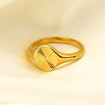 Suri Sunbeam Signet Ring, made of stainless steel in 18K plated gold. Lifestyle shot.