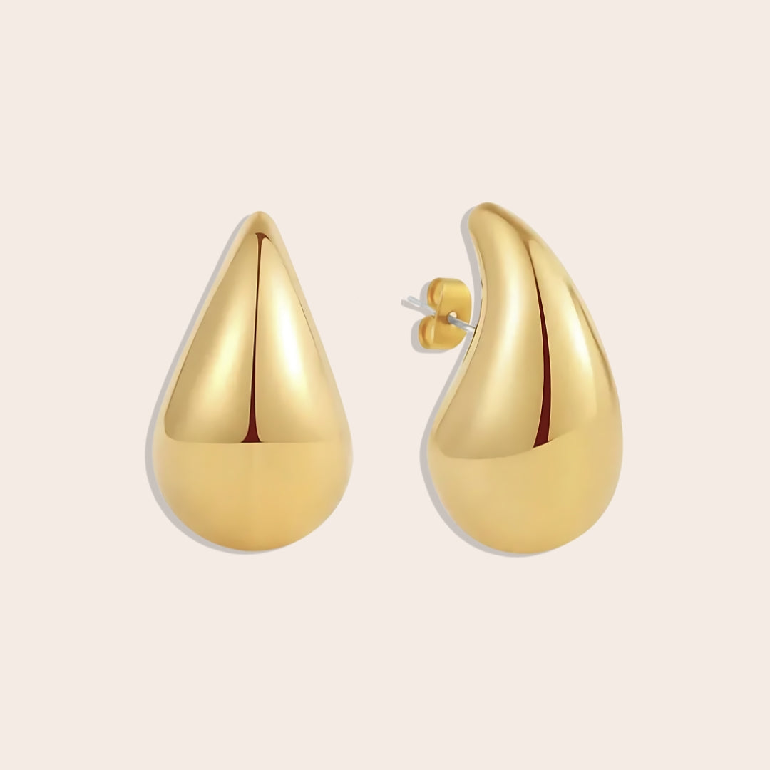 Medium Tais Teardrop Earrings in gold. These eye-catching beauties, crafted from lightweight stainless steel and adorned with lustrous 18K gold plating.